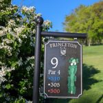 Golf course sign showing hole 9, Par 4, with distances 310, 305, and 300 yards.