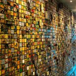 Vast, colorful mosaic wall composed of thousands of small, textured tiles.