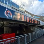 Princeton University stadium exterior with large "PRINCETON" signage under a cloudy sky.