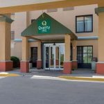 Q Quality Inn hotel entrance with covered portico and modern facade.