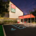 Red Roof Inn exterior at dusk with covered entrance and parking lot.