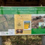 Welcome sign for St. Michaels Farm Preserve, featuring a map and park information.