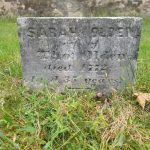 Weathered gravestone in grass with inscription: Sarah Ogden, died 1772, aged 35 years.