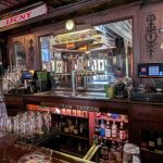 Interior view of a traditional pub, Nottingham Tavern, with a bar and dark wood paneling.