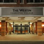 Grand entrance to The Westin Forrestal Village hotel with modern facade and warm lighting.
