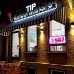 Night shot of the Tip Trenton Ice Cream Parlor with illuminated signage and storefront.