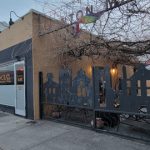 Street view of a low-rise building with "SOCIALA" signage and decorative black silhouette cutouts.