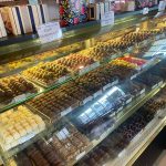 Display case filled with various gourmet chocolates and truffles for sale.