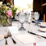 Elegant table setting with wine glasses, floral centerpiece, and place settings at a formal event.